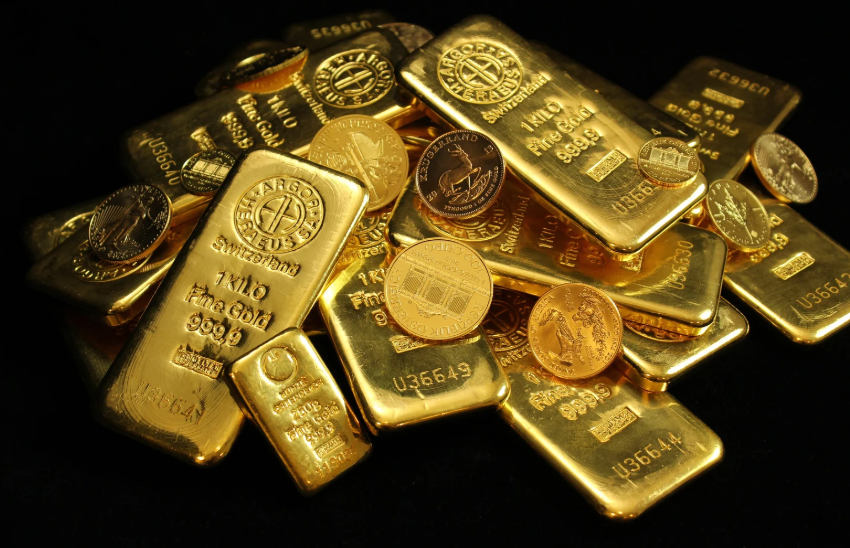 Various gold bars and coins on a black background